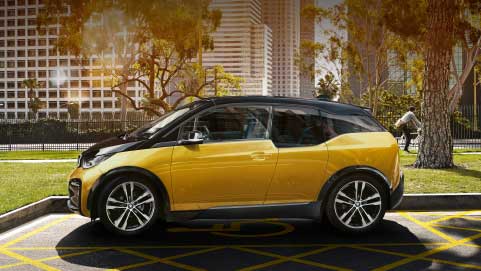 Yellow BMW i3, side profile, parked in suburban environment