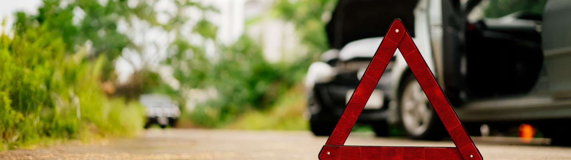 red accident triangle in road