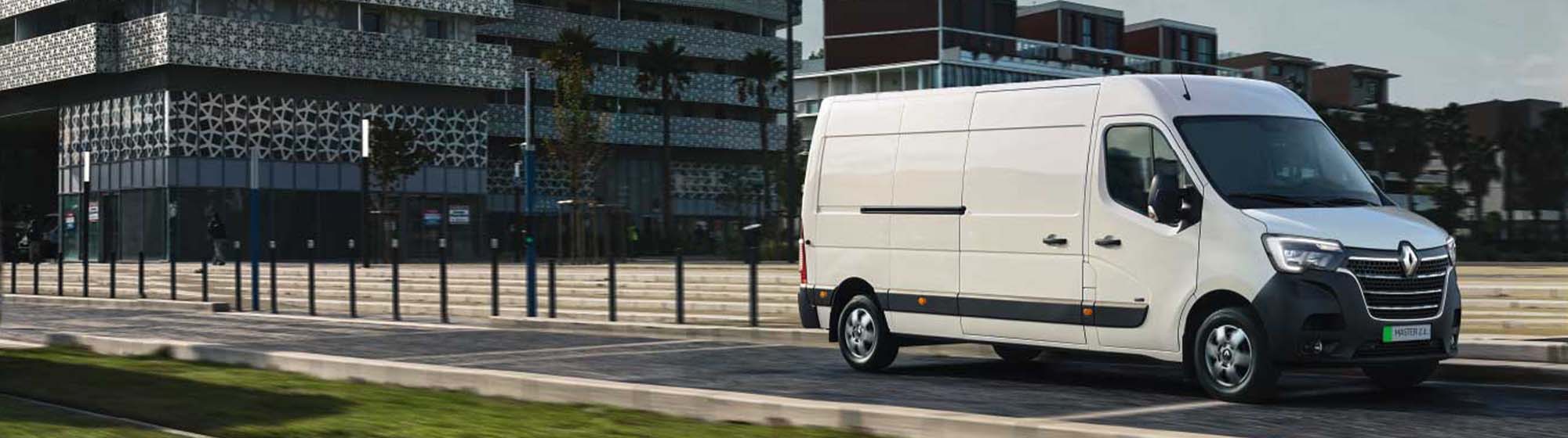 White van driving in a suburban environment