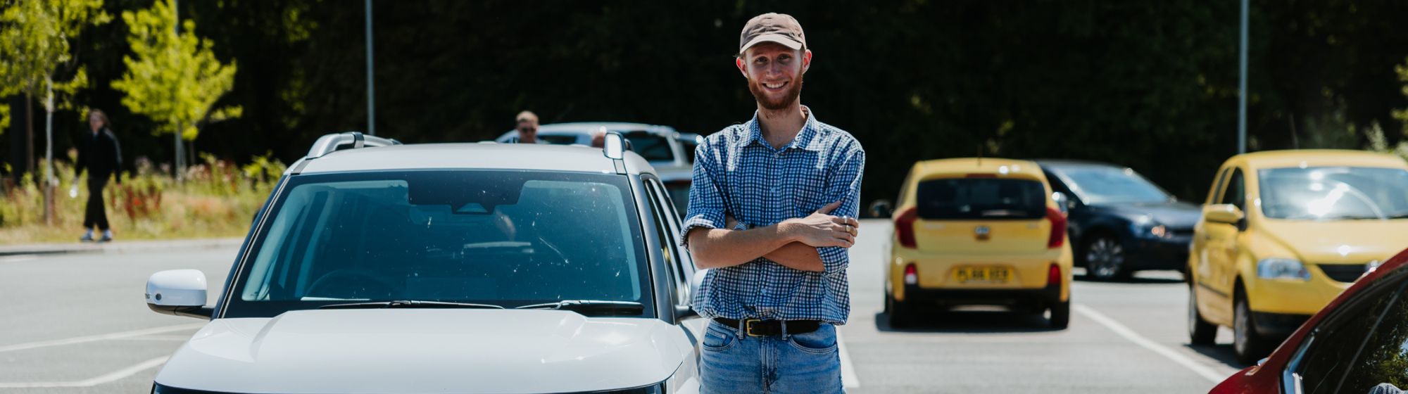 man stood next to vehicle in car park