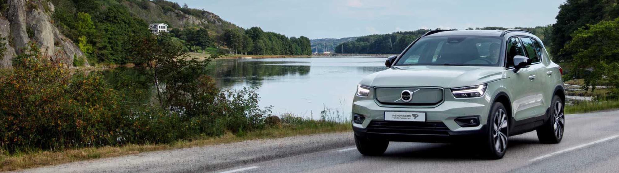 Volvo driving in a countryside setting