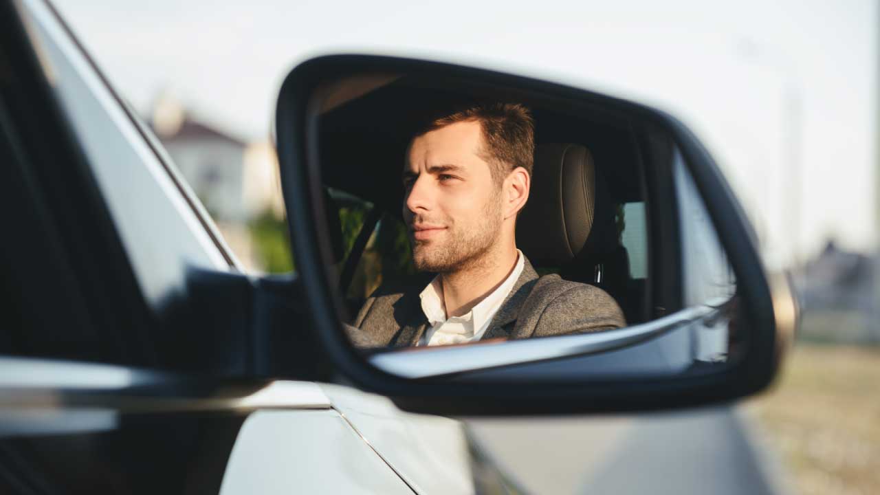 Man Driving Seen In Wing Mirror