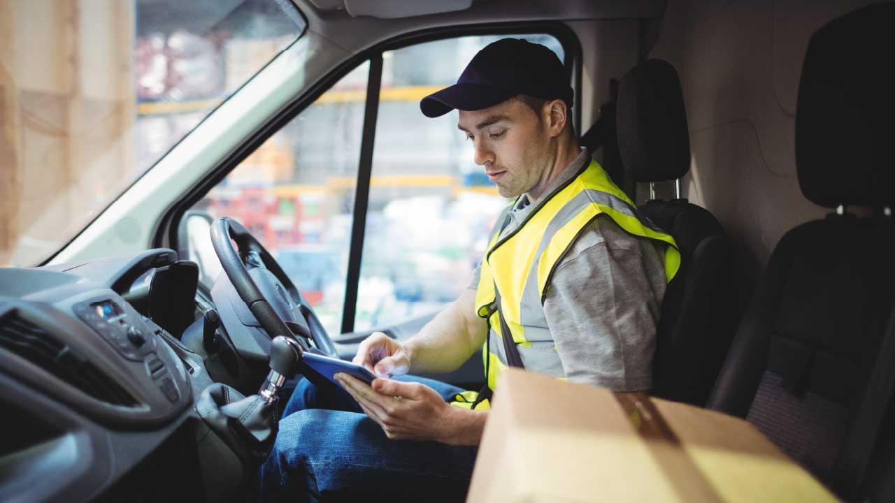 Delivery Driver In Cab Of Van