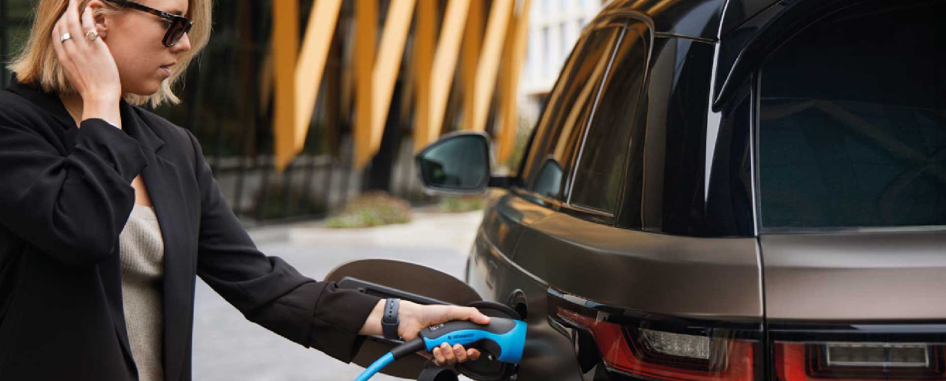 Woman Charging Electric Vehicle