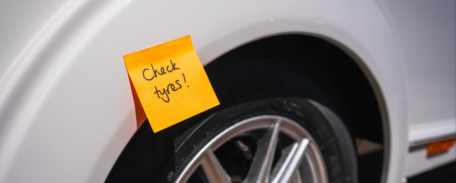 car with post it on wheel