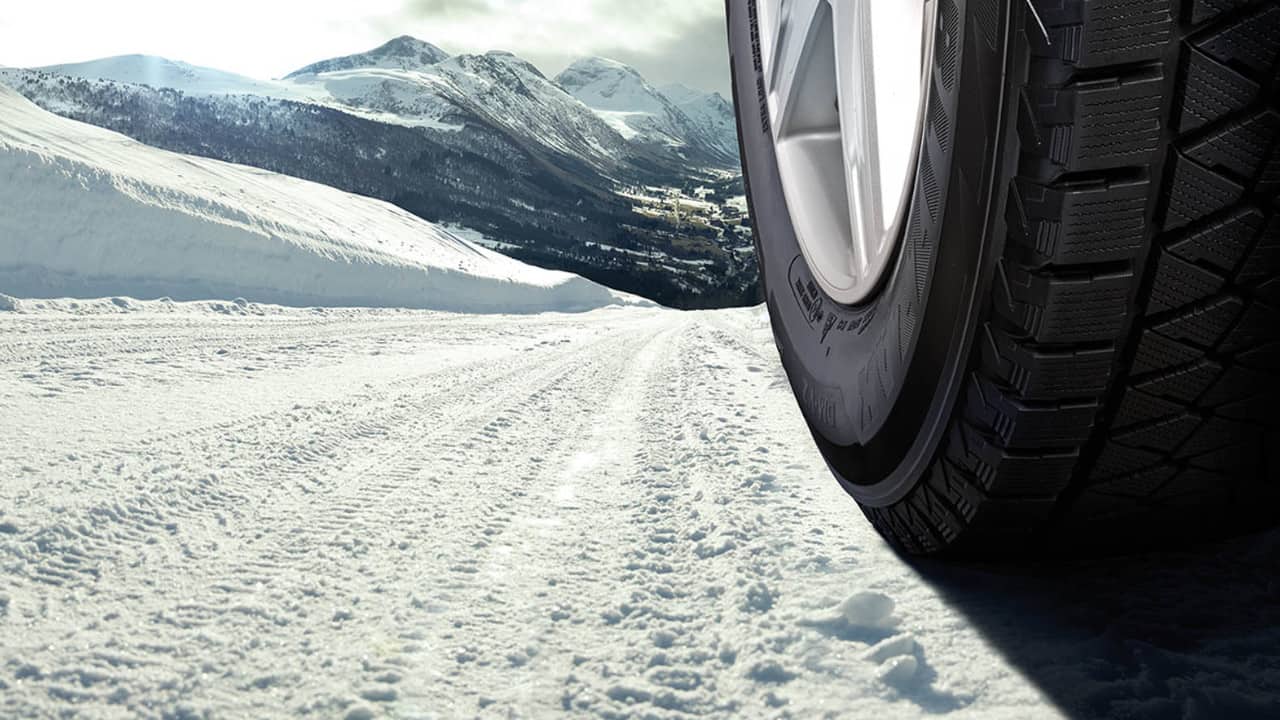Close up of a tyre sidewall, with snowy background