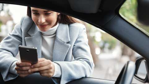 Person on Phone Leaning Through Vehicle Window